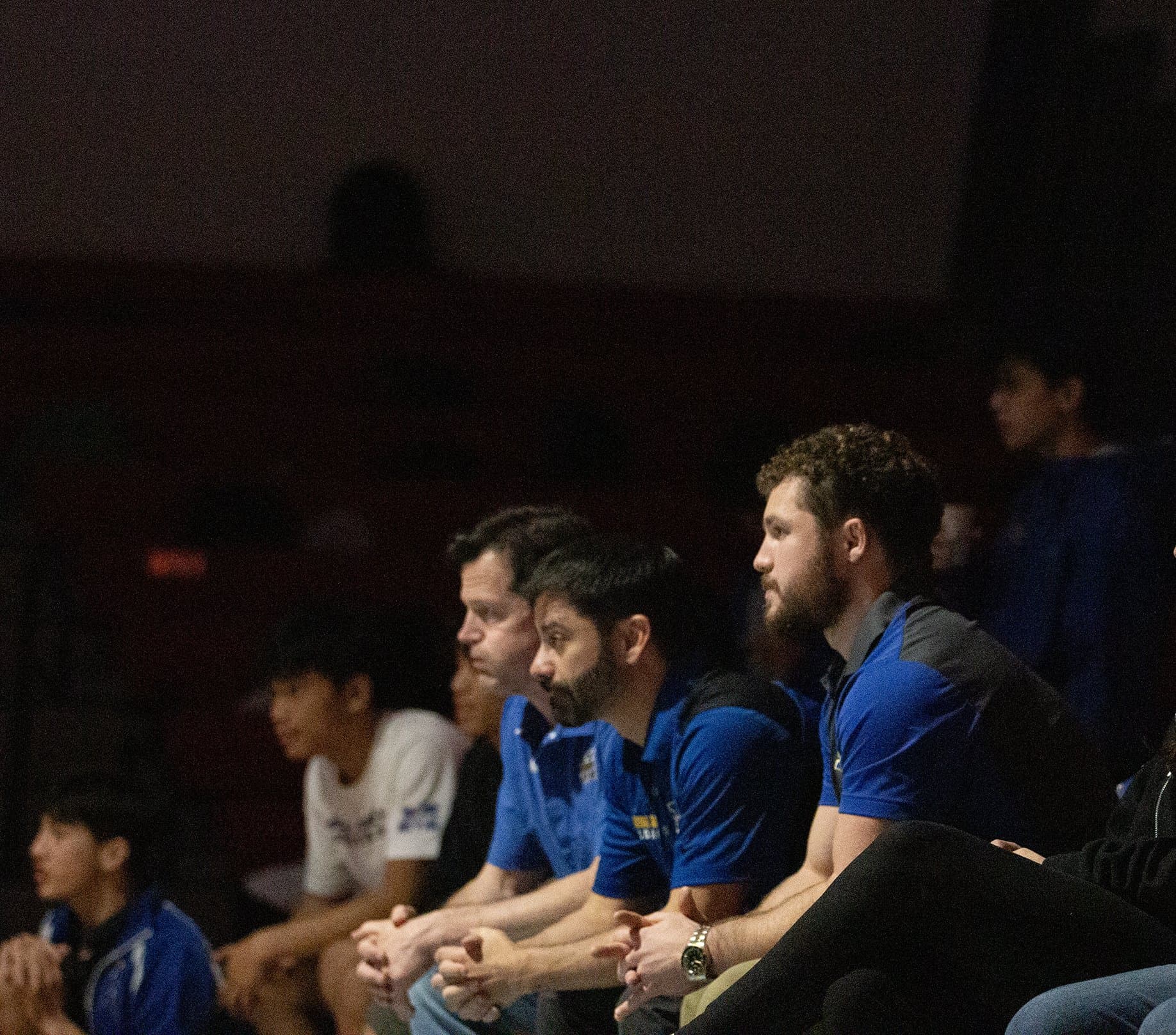 Mira Mesa Wrestling coaching staff bench-side at the 2024 dual at Valhalla