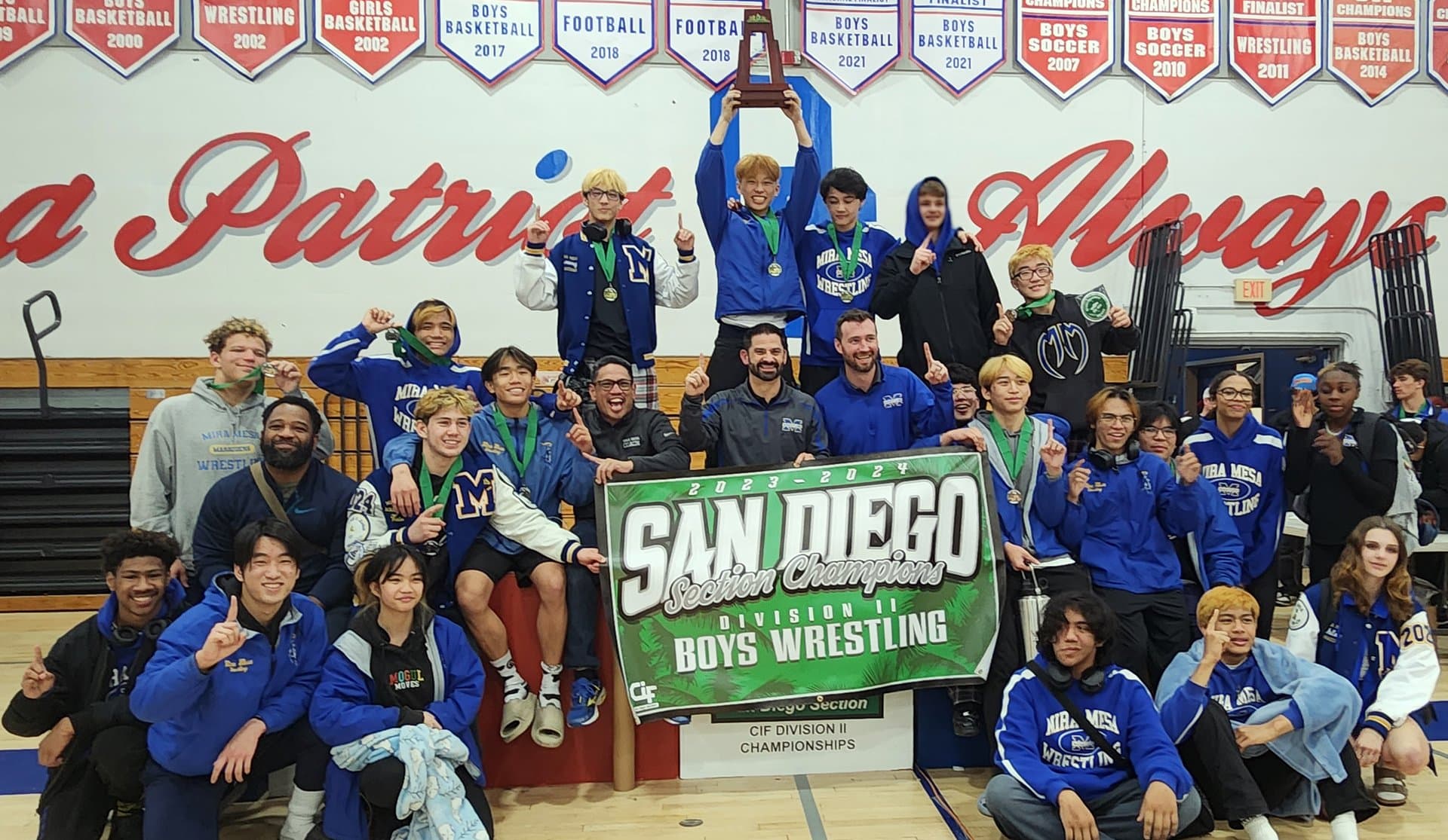Mira Mesa boys wrestling team celebrating the 2024 CIF San Diego Section Division II Championship